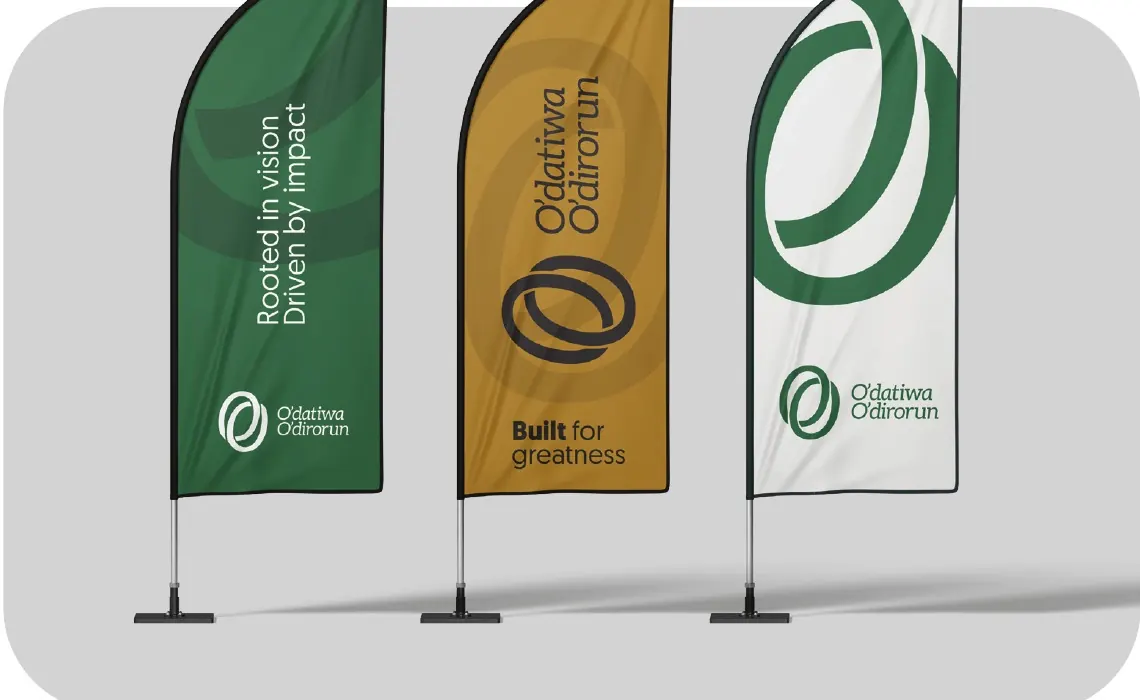 Three feather flags in green, gold and cream carrying the mark.